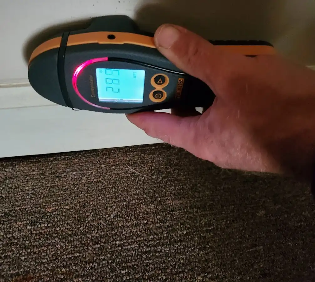Moisture detection at baseboard during Storm Damage Restoration in Wheaton